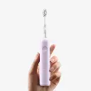 wave-electric-toothbrush-abs-purple-mode-front-view-handheld.webp
